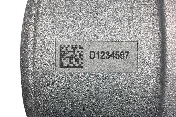 Industrial part marked with human-readable text and 2D barcode